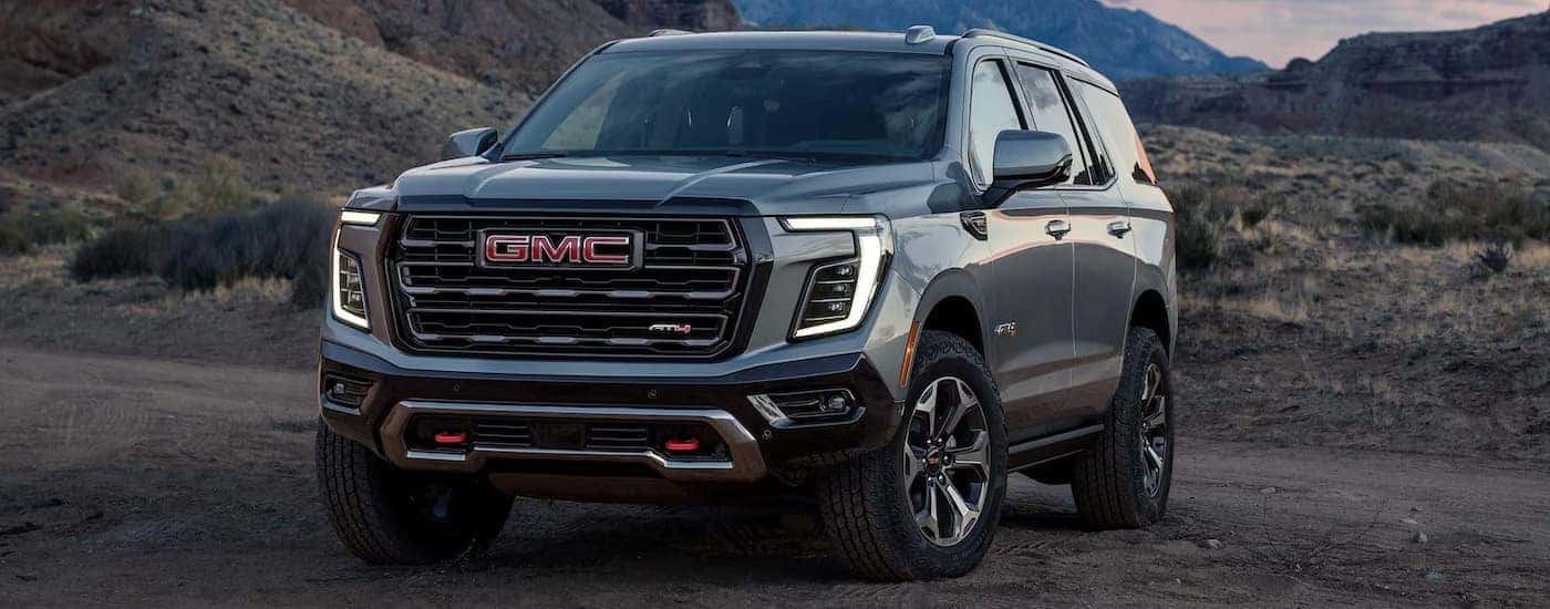 Grey 2026 GMC Yukon for sale parked off-road.