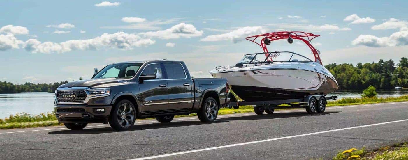 Grey 2024 Ram 1500 towing a boat.
