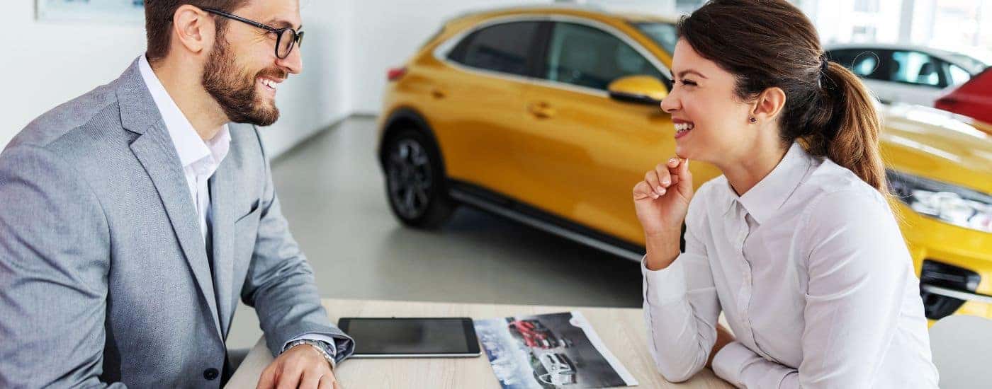 A salesperson is helping a customer look for cars at a Buena Vista Ford dealer.