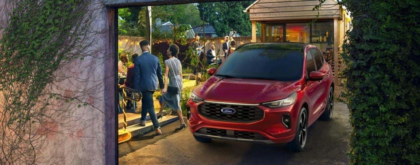 A red 2023 Ford Escape is shown parked in a driveway.