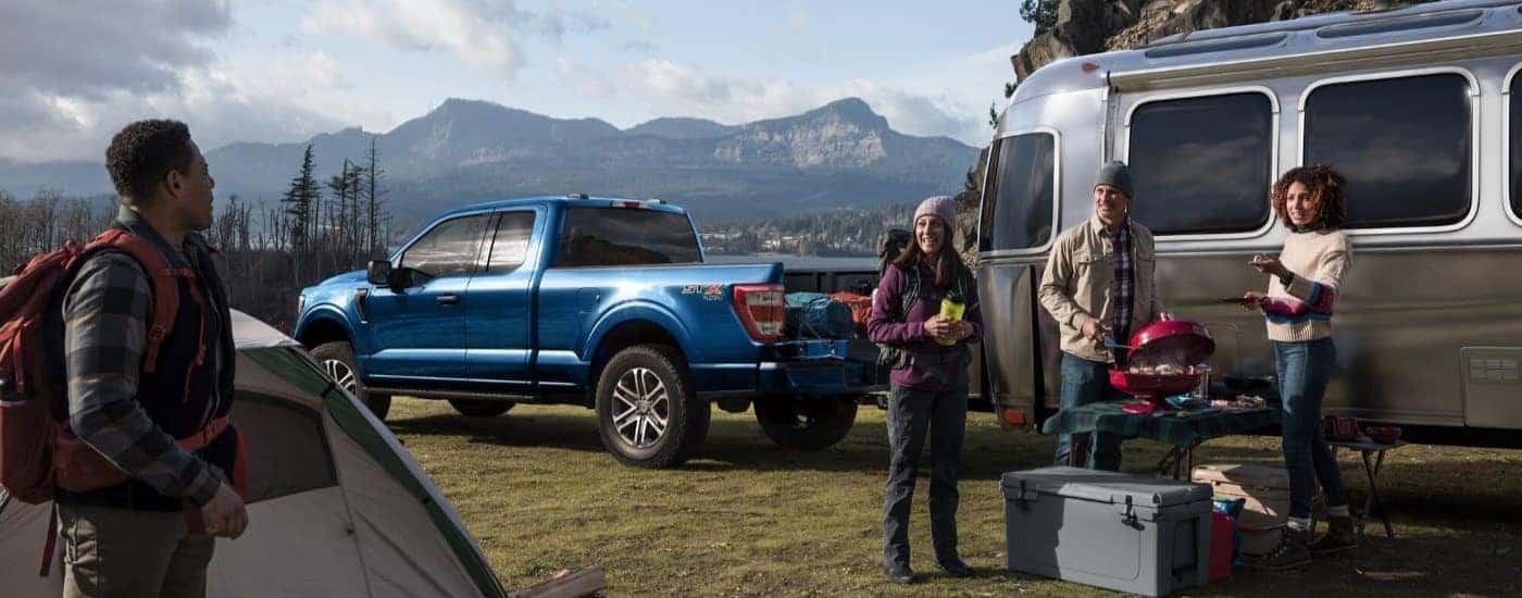 A blue 2022 Ford F-150 STX is shown parked at a campsite after leaving a Fremont Country Ford F-150 dealer.