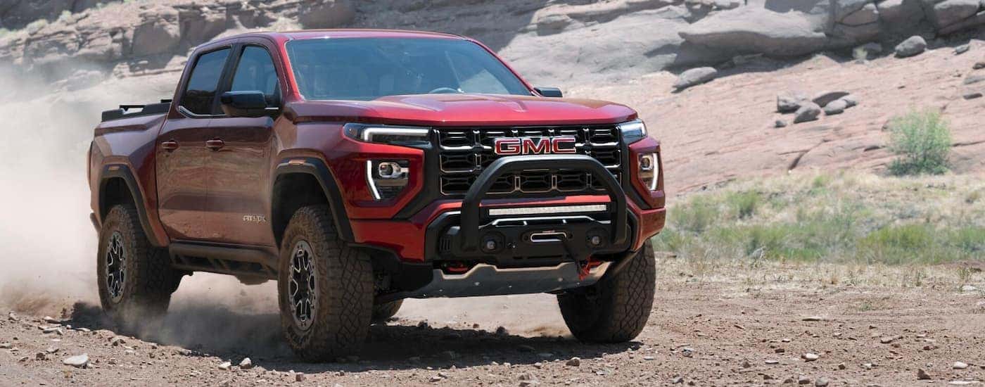 A red 2023 GMC Canyon AT4x is shown from the front at an angle.