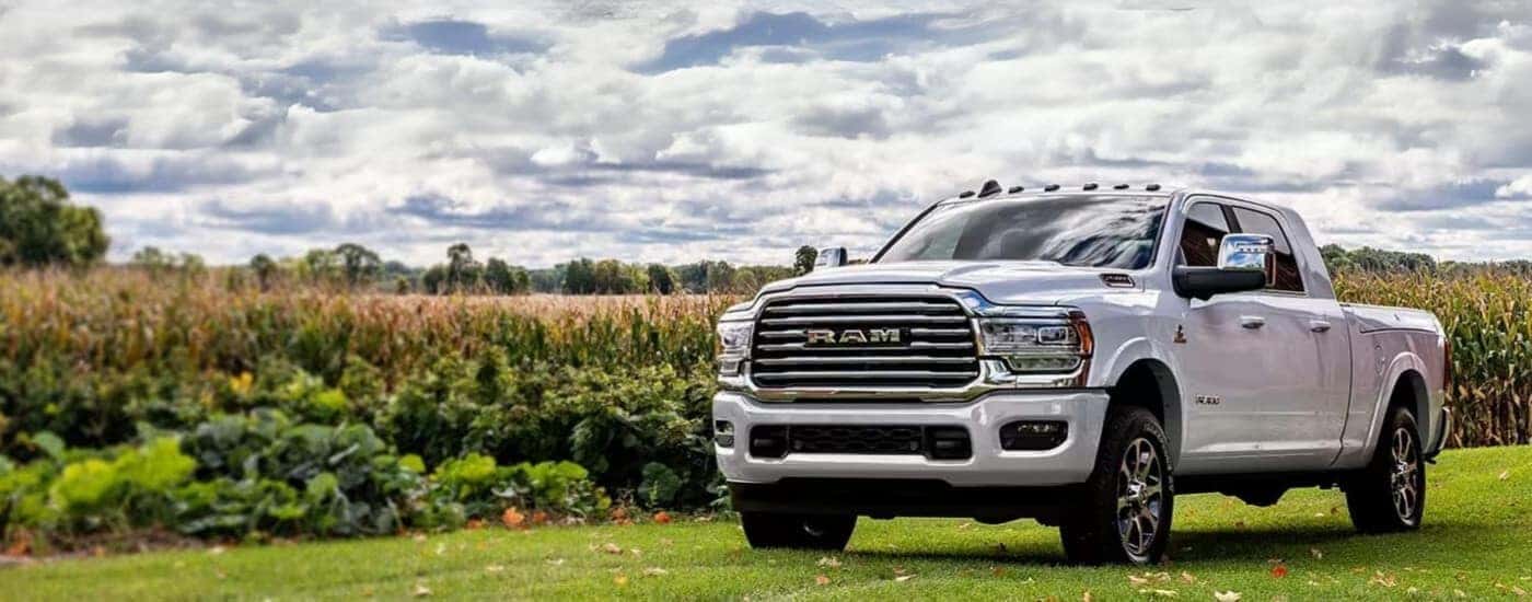 A white 2024 Ram 2500 for sale is shown parked on grass.