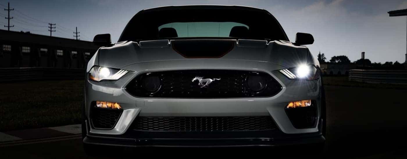 Front of a grey 2023 Ford Mustang Mach 1 at night