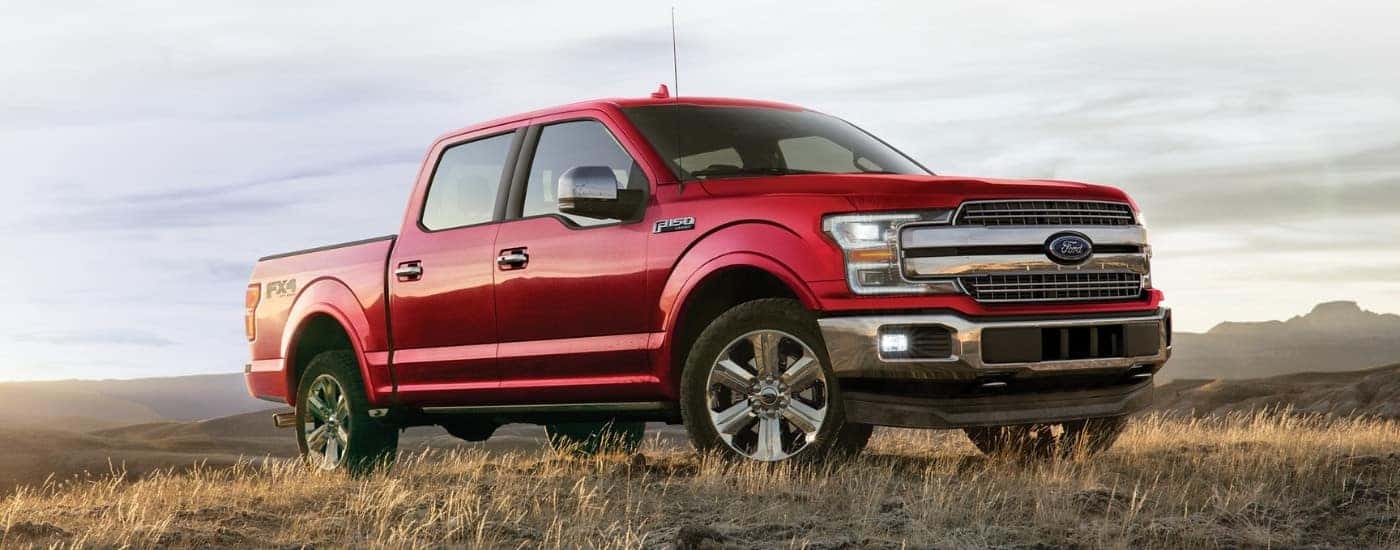 Red 2019 Ford F-150 Lariat parked on a field