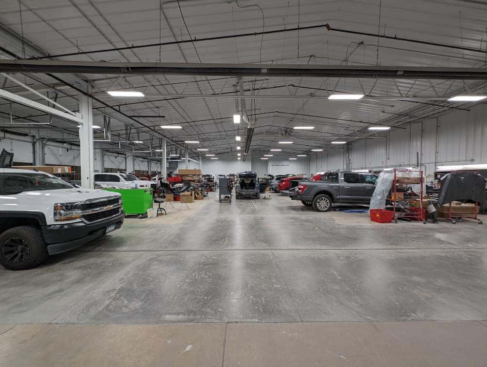 Wide interior view of the Tom Kadlec Auto Body repair facility