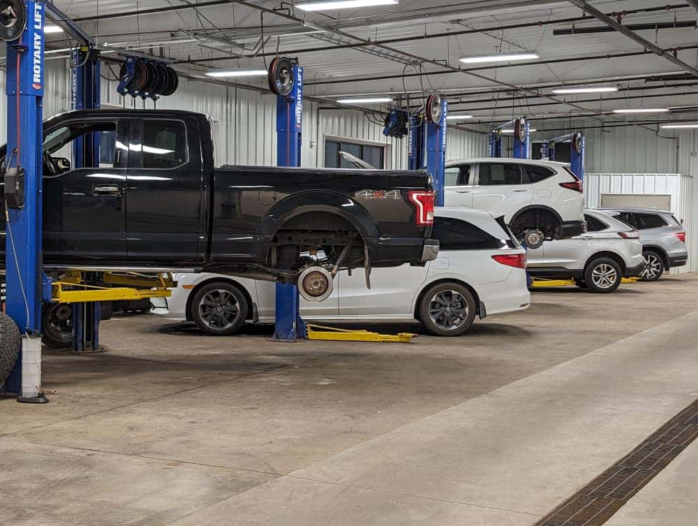 Vehicle repair lifts inside Tom Kadlec Auto Body
