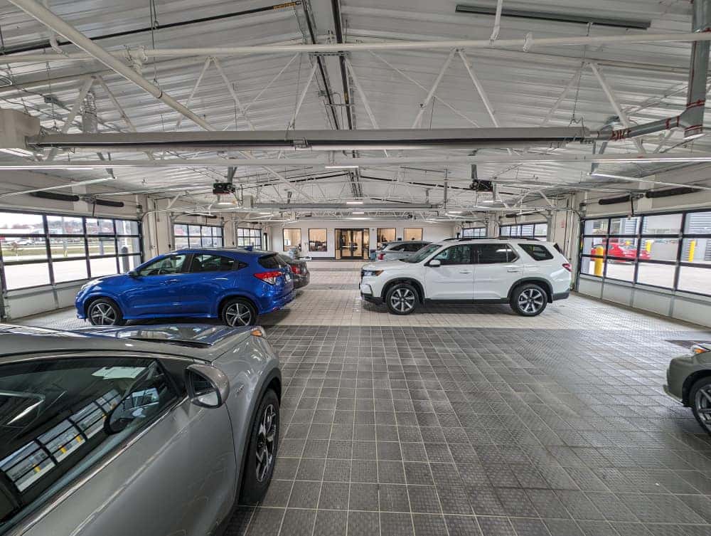 Vehicle staging area inside the Tom Kadlec Auto Body facility in Rochester