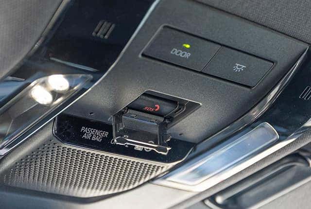 a photo of the sos button in a toyota vehicle that is used for safety connect