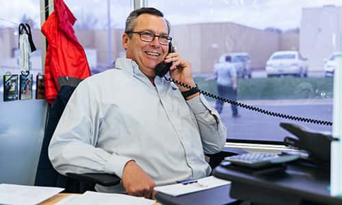 a sales consultant at toyota muscatine in muscatine iowa talking to a customer on the phone