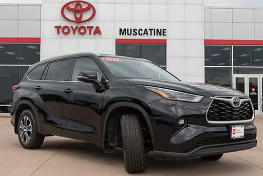 a toyota certified pre owned highlander in front of toyota muscatine