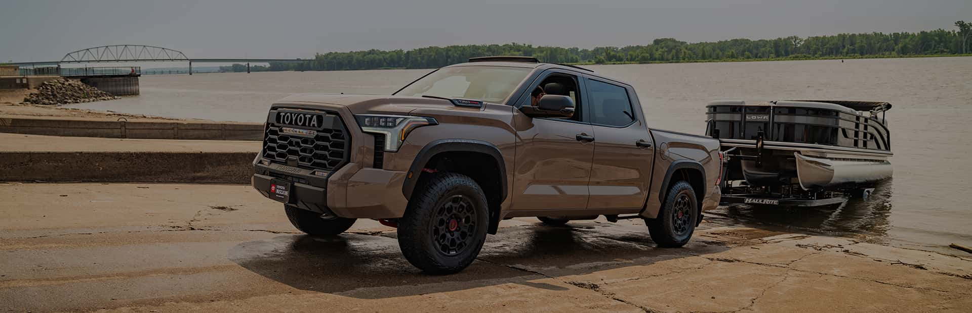 a new toyota tundra from toyota of muscatine pulling a boat out of the mississippi in muscatine iowa