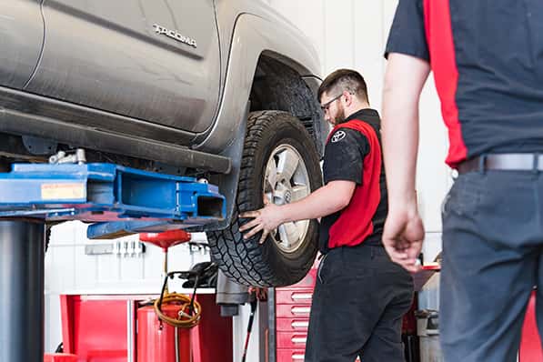 a certified toyota technician rotating tires at toyota muscatine