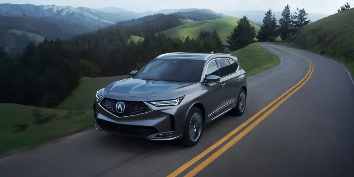 Acura MDX enjoying a smooth ride along a mountainous drive. The Acura MDX is available at West Herr Acura near Williamsville, NY!