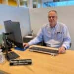 man sitting at computer inside dealership