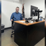west herr manager sitting at desk