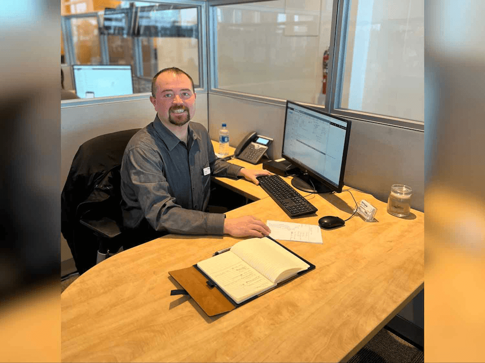 west herr manager sitting at desk