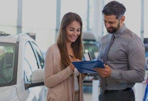 Man and woman going over vehicle paperwork
